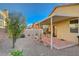 A quaint backyard features low-maintenance desert landscaping with a covered patio, offering a private outdoor living space at 980 Aspen Cliff Dr, Henderson, NV 89011
