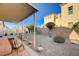 The backyard featuring desert landscaping, brick accents, a covered patio, and a fence at 980 Aspen Cliff Dr, Henderson, NV 89011