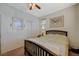 Inviting bedroom with a ceiling fan, a double bed, and a closet for ample storage at 980 Aspen Cliff Dr, Henderson, NV 89011