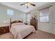 Cozy bedroom featuring a ceiling fan, a comfy bed, and two windows for natural light at 980 Aspen Cliff Dr, Henderson, NV 89011