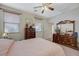 Relaxing bedroom features a ceiling fan, two dressers, and comfortable carpet at 980 Aspen Cliff Dr, Henderson, NV 89011