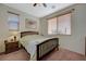 Cozy bedroom with natural light, neutral walls, ceiling fan and carpeted floors at 980 Aspen Cliff Dr, Henderson, NV 89011