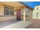 Home exterior featuring a front door with a porch and desert landscaping at 980 Aspen Cliff Dr, Henderson, NV 89011
