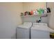 Efficient laundry room features modern washer and dryer appliances with a storage shelf, maximizing space and convenience at 980 Aspen Cliff Dr, Henderson, NV 89011