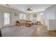 Spacious living room with ceiling fan, neutral carpet and tile floors and lots of natural light at 980 Aspen Cliff Dr, Henderson, NV 89011