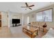 Bright living room with ceiling fan, neutral carpet and tile floors and large window at 980 Aspen Cliff Dr, Henderson, NV 89011