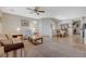Comfortable living room flows into the dining area with neutral carpet and tile flooring at 980 Aspen Cliff Dr, Henderson, NV 89011