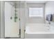 Bathroom showcasing a separate shower, soaking tub, and bright natural light at 7940 Violet Dawn St, Las Vegas, NV 89149