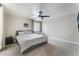 Spacious carpeted bedroom features a ceiling fan, large windows, and neutral decor at 7940 Violet Dawn St, Las Vegas, NV 89149