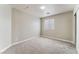 A bright bedroom with neutral walls and gray carpet at 7940 Violet Dawn St, Las Vegas, NV 89149