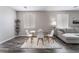 Bright dining area with modern chairs, glass table, and view to the sectional sofa at 7940 Violet Dawn St, Las Vegas, NV 89149