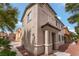 Charming two-story home with a neutral stucco finish, red stone landscaping and lovely architectural details at 7940 Violet Dawn St, Las Vegas, NV 89149
