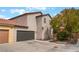 Two-story stucco home with a two-car garage and well-maintained landscaping at 7940 Violet Dawn St, Las Vegas, NV 89149