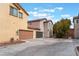 Two-story stucco home with a two-car garage and well-maintained landscaping at 7940 Violet Dawn St, Las Vegas, NV 89149