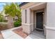 Inviting front entrance with stucco columns, tiled roof and tidy landscaping creates curb appeal at 7940 Violet Dawn St, Las Vegas, NV 89149