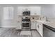 Bright kitchen features stainless steel appliances, white cabinetry, and modern fixtures at 7940 Violet Dawn St, Las Vegas, NV 89149