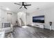 Comfortable living room with sleek flooring, a sectional sofa, a staircase, and a mounted television at 7940 Violet Dawn St, Las Vegas, NV 89149