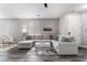 Bright living room featuring a large sectional sofa, modern decor, and stylish flooring at 7940 Violet Dawn St, Las Vegas, NV 89149
