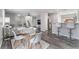 Open living space with a dining area, living area, and kitchen bar seating at 7940 Violet Dawn St, Las Vegas, NV 89149