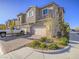 Well-maintained townhouse with a two-car garage, manicured landscaping, and a brick-paved driveway at 10768 Ditchburn Ct, Las Vegas, NV 89166