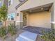 Welcoming covered porch with brick flooring, complemented by tasteful landscaping and stylish exterior lighting at 10768 Ditchburn Ct, Las Vegas, NV 89166