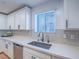 Close up of a kitchen featuring a stainless steel sink, black faucet, and sleek backsplash at 10768 Ditchburn Ct, Las Vegas, NV 89166