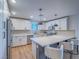 Stylish kitchen with white cabinets, stainless steel appliances, quartz countertops, and a breakfast bar at 10768 Ditchburn Ct, Las Vegas, NV 89166