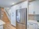 Bright kitchen with stainless steel refrigerator and plenty of cabinet space next to stairs at 10768 Ditchburn Ct, Las Vegas, NV 89166