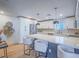 Bright kitchen with white cabinets, stainless steel appliances, quartz countertops, and modern pendant lighting at 10768 Ditchburn Ct, Las Vegas, NV 89166