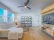 Bright living room features a plush sofa, sleek ceiling fan, and modern shelving for stylish storage at 10768 Ditchburn Ct, Las Vegas, NV 89166