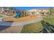 Colorful playground with a slide and other equipment surrounded by woodchips in a community area at 10768 Ditchburn Ct, Las Vegas, NV 89166