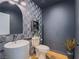 Chic powder room with unique textured wallpaper, a modern sink, and stylish fixtures at 10768 Ditchburn Ct, Las Vegas, NV 89166