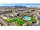 An outdoor pool and clubhouse are surrounded by modern homes and desert landscaping at 10985 Limeslice Ave # 2, Las Vegas, NV 89135