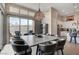 Open dining area with modern lighting and large windows that provide an abundance of natural light at 10985 Limeslice Ave # 2, Las Vegas, NV 89135