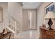 Welcoming entryway with a staircase, marble-top furniture, and tiled flooring at 10985 Limeslice Ave # 2, Las Vegas, NV 89135