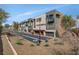 Modern townhome featuring multi-tone paint, personal garages and desert landscaping at 10985 Limeslice Ave # 2, Las Vegas, NV 89135