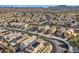 Expansive aerial view of a residential neighborhood with neatly lined homes and solar panels in a desert environment at 117 Blue Trout Ave, Henderson, NV 89011