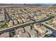 High-angle aerial shot of a neatly organized suburban area surrounded by a desert landscape, highlighting uniformity and scenery at 117 Blue Trout Ave, Henderson, NV 89011