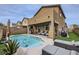 Inviting backyard pool with lounge area and covered patio, ideal for outdoor entertaining at 117 Blue Trout Ave, Henderson, NV 89011