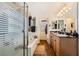 Bathroom featuring double sinks, soaking tub, and a separate shower with glass doors at 117 Blue Trout Ave, Henderson, NV 89011