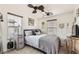 Cozy bedroom featuring a comfortable bed, stylish decor, and natural light from the window at 117 Blue Trout Ave, Henderson, NV 89011