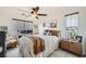 Comfortable bedroom offers natural light, a ceiling fan, and a dedicated workspace at 117 Blue Trout Ave, Henderson, NV 89011