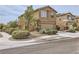 Charming two-story home with brown stucco, complemented by well-maintained landscaping and a two-car garage at 117 Blue Trout Ave, Henderson, NV 89011