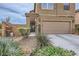 Warm two-story home with a two-car garage, featuring a welcoming entrance with wrought iron gate at 117 Blue Trout Ave, Henderson, NV 89011
