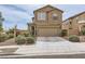 Inviting two-story home featuring a two-car garage, complemented by desert landscaping for a modern touch at 117 Blue Trout Ave, Henderson, NV 89011