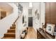 Bright and airy foyer with beautiful hardwood floors, staircase, and elegant decor at 117 Blue Trout Ave, Henderson, NV 89011