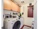 Convenient laundry room with modern washer and dryer, ample cabinetry, and organized storage at 117 Blue Trout Ave, Henderson, NV 89011