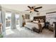 Spacious main bedroom with a ceiling fan, access to balcony, and stylish decor at 117 Blue Trout Ave, Henderson, NV 89011