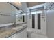 Bathroom featuring granite countertop, mirror, and a tiled walk-in shower at 1334 Shimmering Glen Ave, Henderson, NV 89014