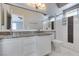Double sink bathroom with large mirror and a tiled walk in shower at 1334 Shimmering Glen Ave, Henderson, NV 89014